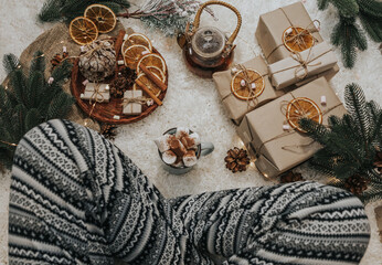 lady in warm winter home pants sits on a soft blanket. Still life details in home interior. Cozy...