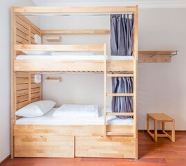 Hostel dormitory beds arranged in room