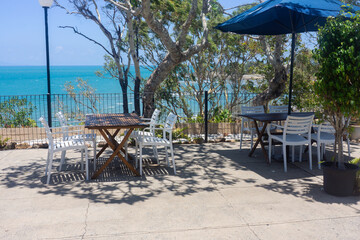 Cafe seating overlooking a stunning ocean view.