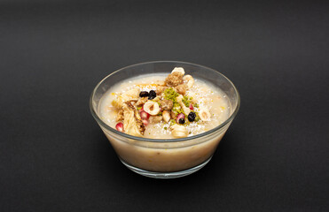 Closeup of traditional Turkish Dessert Asure or Ashura (aka Noah Pudding) in white bowls isolated...