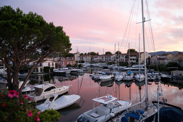 Fototapeta na wymiar View on houses, roofs, canals and boats in Port Grimaud, Var, Provence, France during sunset