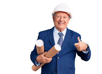 Senior handsome grey-haired man wearing architect hardhat holding blueprints smiling happy and positive, thumb up doing excellent and approval sign