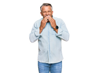 Middle age grey-haired man wearing casual clothes laughing and embarrassed giggle covering mouth...