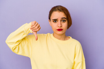 Young arab mixed race woman showing a dislike gesture, thumbs down. Disagreement concept.