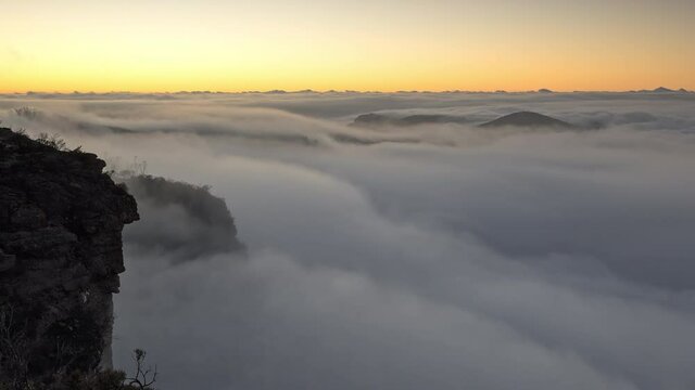 View of fog rolling through the canyon at Govetts Leap in the Blue Mountains during sunrise.