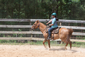 Teenage girl on horseback in a Texas corral