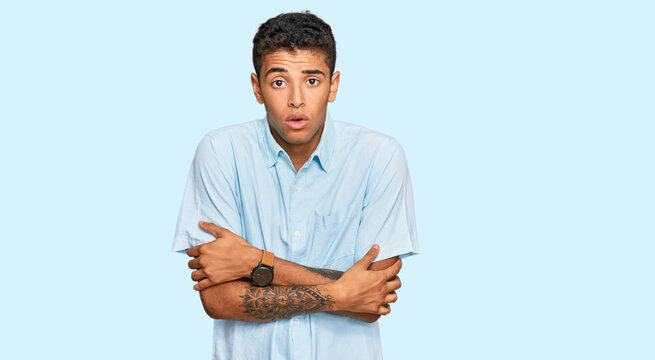 Young handsome african american man wearing casual clothes shaking and freezing for winter cold with sad and shock expression on face