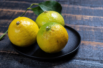 Fresh ripe bergamot orange fruits, fragrant citrus used in earl grey tea, medicine and spa treatments - obrazy, fototapety, plakaty