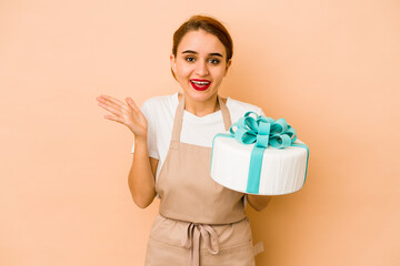 Young skinny arab pastry chef woman receiving a pleasant surprise, excited and raising hands.