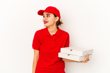 Young skinny arab pizza delivery girl joyful and carefree showing a peace symbol with fingers.