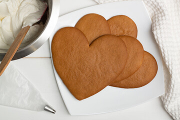 Step-by-step heart-shaped cake recipe instructions. Step 8: Bake the cakes for 10 minutes at 180 degrees C, flat lay.