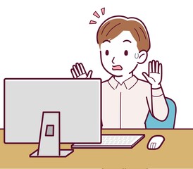 A man in a pink shirt using a computer