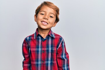 Adorable latin kid wearing casual clothes with a happy and cool smile on face. lucky person.