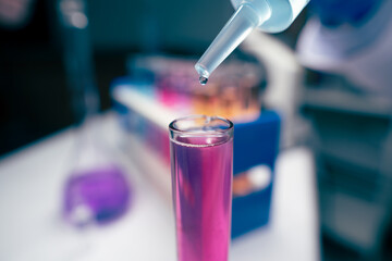 Liquid drop falling into test tubes