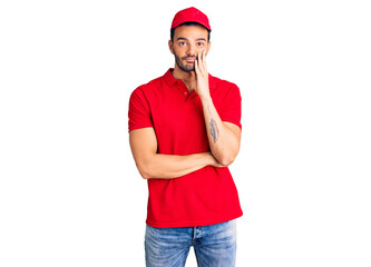 Young handsome hispanic man wearing delivery courier uniform thinking looking tired and bored with...