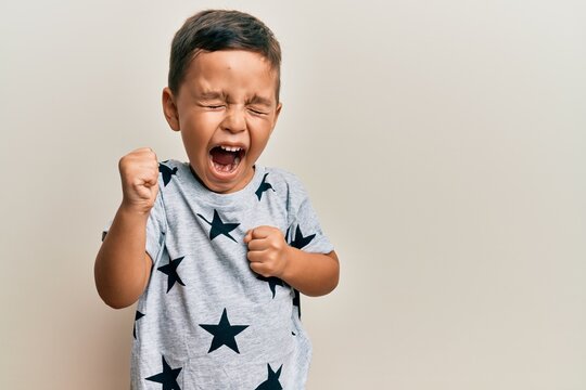 Adorable Latin Toddler Wearing Casual Clothes Celebrating Surprised And Amazed For Success With Arms Raised And Eyes Closed