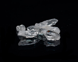 Clear Satyaloka Quartz from Southern India isolated on a black mirror background.
