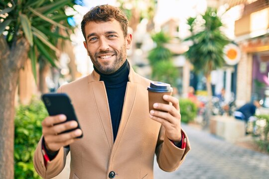 Handsome business man wearing elegant jacket using smartphone smiling happy outdoors