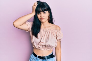 Young hispanic girl wearing casual clothes confuse and wonder about question. uncertain with doubt,...