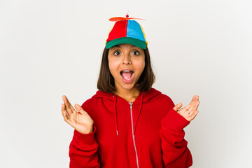 Young hispanic woman wearing a cap with propeller isolated surprised and shocked.