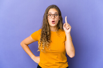 Fototapeta premium Young caucasian cute woman pointing upside with opened mouth.