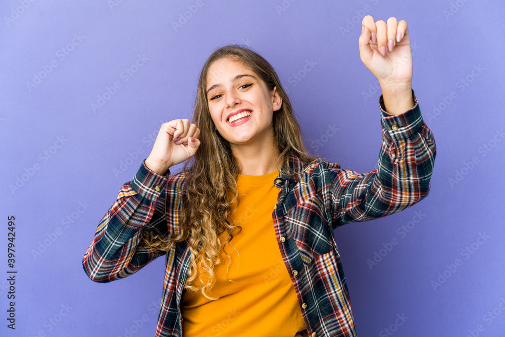 Wall mural young caucasian cute woman dancing and having fun.