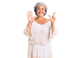 Senior woman with gray hair wearing bohemian style showing and pointing up with fingers number seven while smiling confident and happy.