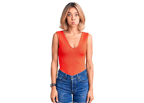 Beautiful caucasian woman wearing casual clothes puffing cheeks with funny face. mouth inflated with air, crazy expression.