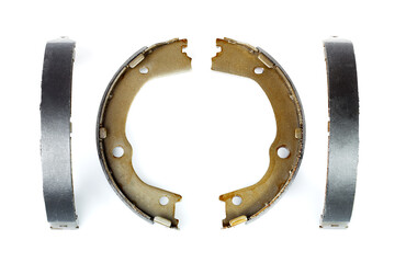 set of drum brake pads with asbestos alloy on steel car spare parts isolated on white background...
