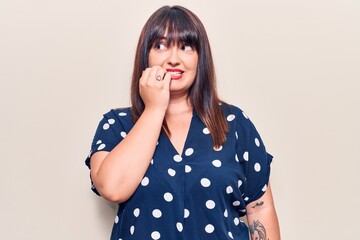 Young plus size woman wearing casual clothes looking stressed and nervous with hands on mouth...