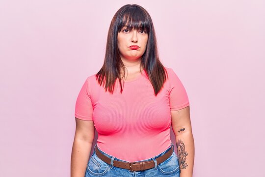 Young plus size woman wearing casual clothes depressed and worry for distress, crying angry and afraid. sad expression.