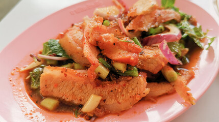 Thinly sliced grilled pork.  Spicy Thai salad with roasted chili powder, ground roasted rice an d lemon juice.