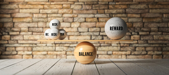 wooden scale balancing one big ball and four small ones with message RISK, REWARD and BALANCE in...