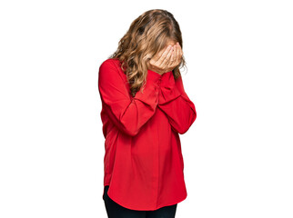 Middle age blonde woman wearing casual shirt over red background with sad expression covering face with hands while crying. depression concept.