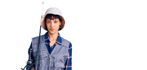 Young brunette woman with short hair wearing fisherman equipment thinking attitude and sober expression looking self confident