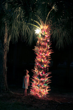 little girl looking at Christmas starlight