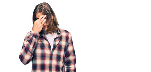 Handsome caucasian man with long hair wearing hipster shirt tired rubbing nose and eyes feeling fatigue and headache. stress and frustration concept.