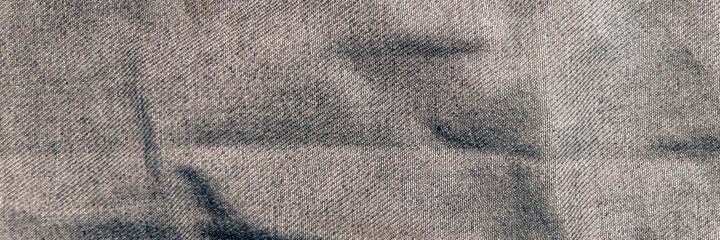 fabric grunge background, real cotton denim brown, wrinkled, frayed, close