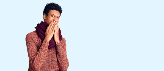 Young african american man wearing casual winter sweater and scarf laughing and embarrassed giggle...
