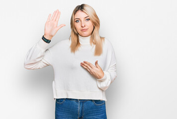 Young caucasian woman wearing casual winter sweater swearing with hand on chest and open palm, making a loyalty promise oath