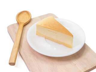 The close up of sliced yummy cheesecake bakery sweet dessert and wooden spoon on wood cutting board isolated on white background.