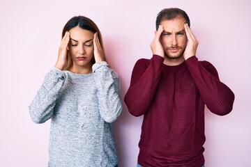 Beautiful couple wearing casual clothes with hand on head for pain in head because stress....
