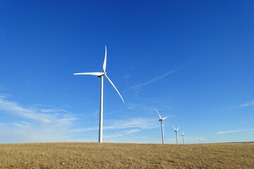 A closeup isolated vertical photo of Wind turbines in Alberta, Canada. Renewable energy concept.
