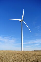 Fototapeta premium A closeup isolated vertical photo of Wind turbines in Alberta, Canada. Renewable energy concept.