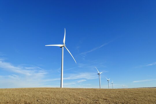 A closeup isolated vertical photo of Wind turbines in Alberta, Canada. Renewable energy concept.