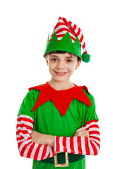 Adorable 10 year old boy dressed in an elf costume standing with arms crossed showing Christmas spirit isolated on a white background