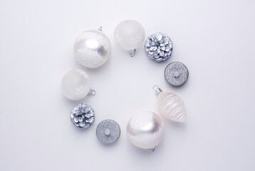 White balls silver pine cone and artificial candles make a Christmas wreath and change places isolated on white background from above. Flat lay holidays with copy space