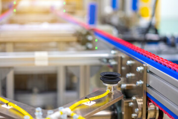 Automation concept: View of conveyor unit in robot glass sealing machine of automotive factory.