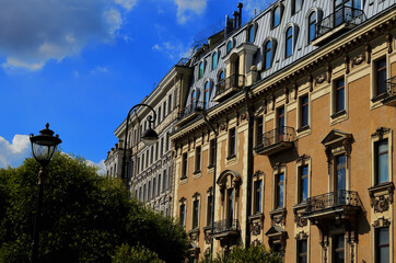 The building with metal balconies and stucco on the facade. Walk through the streets of the city. Russia St. Petersburg, 20.08.2020. High quality photo