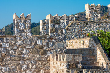 part of the medieval Fort. the walls and towers are made of large rough stone blocks. historic, heritage background © Celt Studio
